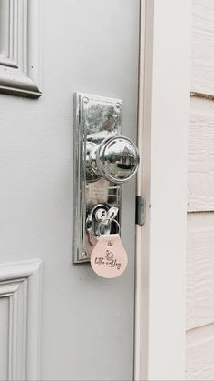 a door handle with a tag attached to it and a key on the lock hole