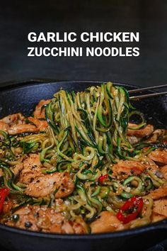 a skillet with noodles and chicken in it on a table next to the words garlic chicken zucchini noodles