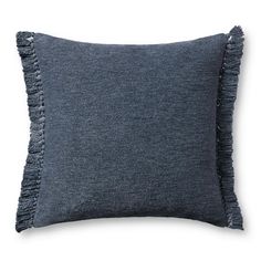 a dark blue pillow with fringes on the front and back, against a white background