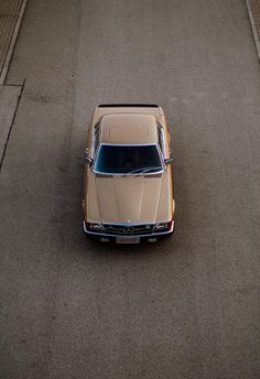 an old car is parked on the street