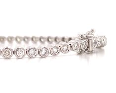 Bezel set diamond jewelry is so pretty and classic. This bezel set tennis bracelet is made of 18K white gold that is inlaid with high quality round cut diamonds of 2.28 carat total weight. All of the diamonds are clean, round in shape and have a brilliant cut. The facets sparkle so wonderfully, you will feel and look incredibly luxurious.Metal: 18K White GoldDiamond Weight: 2.28ct twDiamond Shape: 57 Round Brilliant-cutSetting Type: Bezel Set Length: 17.5cm Estimated production time is 4 - 5 wee Bezel Set Diamond, Bezel Diamond, Tennis Bracelet, Round Cut Diamond, Bezel Setting, So Pretty, Round Brilliant, Round Cut, Diamond Jewelry