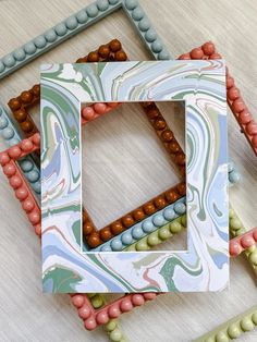 three different colored frames sitting on top of a table