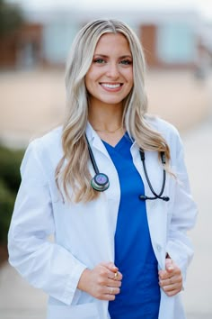 a woman wearing a white lab coat and blue shirt