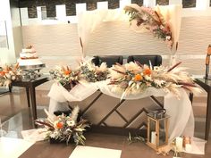 the table is decorated with flowers and feathers