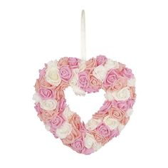 a heart shaped wreath with pink and white flowers