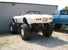 a monster truck parked in front of a building