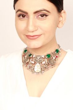 Silver toned choker with cutwork patterns, green quartz gemstone and kundan embellishments.
Type: Quartz, Kundan
Composition: Silver
Color: Green
Other Details: 
Handcrafted
Dimensions: L x W (in inches): 15 x 2.4
Disclaimer: The jewellery is handcrafted therefore variations may occur. - Aza Fashions Traditional Jeweled Kundan Necklace, Fusion Style Kundan Necklace With Gemstone, Green Kundan Necklace With Intricate Design, Green Kundan Necklace With Intricate Fusion Design, Elegant Silver Kundan Necklace, Designer Kundan Necklace For Festive Occasions, Elegant Cutdana Choker, Silver Kundan Choker, Green Kundan Meenakari Necklace