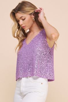 Sparkle All the Way!With shimmery and delicate sequins, this eye-catching top is ready to be worn on your next rendezvous! Makes for perfect pairing for jeans or dressier shorts, add a layer of your favorite blazer on those cooler nights. Materials & Care - Content: 95% Polyester, 5% Spandex- Care: Machine wash cold, tumble dry low, cool iron if needed- Made in the USA Size & Description -V neckline-Tank Top-Sequin-Lined-Loose Fit-Model is wearing size S Glamorous V-neck Top For Night Out, Glamorous V-neck Tops For Date Night, Trendy V-neck Party Tops, Fitted V-neck Top With Contrast Sequin, Trendy V-neck Tops For Party, Fitted Purple Sequin Top, Trendy Shimmer Tops For Party, Chic Sparkling Tops For Party Season, Glamorous Purple Sequin Top