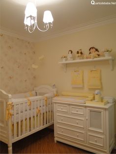 a baby's room with two cribs and a chandelier hanging from the ceiling