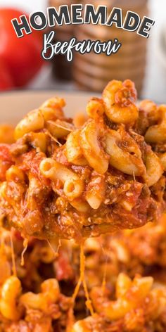 a spoon full of pasta on top of a plate with tomatoes in the background and text overlay that reads homemade peperoni