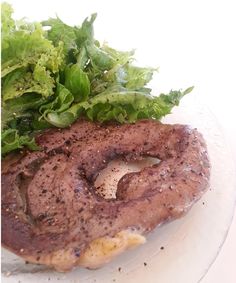 a close up of a plate of food with meat and lettuce on it