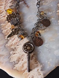 Vintage Necklace with Skeleton Key, Small key real and one fake key, with many Steam punk charms, glass beads with scroll work and caps, and fake coins. Largest Charm is the skeleton key and chain at 2 3/4 inches. Necklace can be worn at 18.5 to 21.5 inches, but even shorter due to Lobster clasp and chain. Necklace comes Gift Boxed and USPS Tracking for your convenience. The Skeleton Key, Steam Punk Jewelry, Scroll Work, Punk Vintage, The Skeleton, Punk Jewelry, Steampunk Jewelry, Skeleton Key, Steam Punk