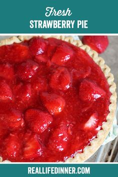 a close up of a pie with strawberries on it