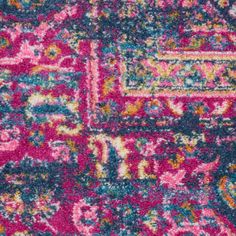 an area rug with various colors and patterns on the carpet, including pink, blue, green