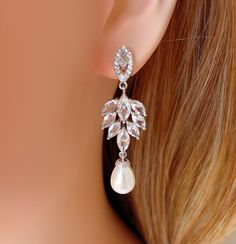 a close up of a pair of earrings on a mannequin's head