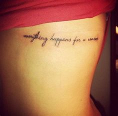 a woman with a tattoo saying something happens for a reason on her side ribcage