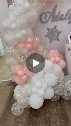 a balloon arch with snowflakes and stars on it in front of a baby's room