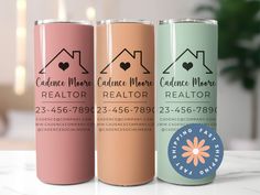 three cans of realtor products sitting on a table