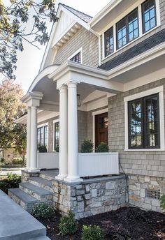 a house with white columns and black shutters