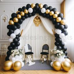 a black and gold wedding arch with balloons