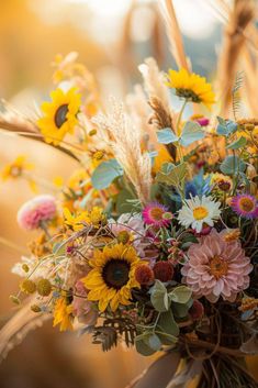 a bouquet of sunflowers and other wild flowers