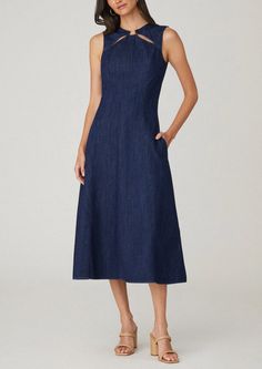 Chic sleeveless denim midi dress. This style features a round neckline with gold ring trim inserted on the front with cut-outs, a fitted body with flattering princess seams that go into a midi length A-line skirt with side seam pockets. Unlined. Hidden back zipper. 100% Cotton. Dry clean only. Color: Indigo A-line Denim Blue Denim Dresses, Mid-length Denim Dress With Pockets In Medium Wash, Luxury A-line Denim Dress, Non-stretch Medium Wash Denim Dress, Non-stretch Cotton Denim Dress In Medium Wash, Denim Midi Dress, Body Dress, Princess Seam, Midi Length