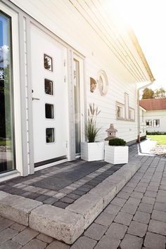 a white door and steps leading to a house