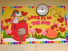 a bulletin board that says love is in the air with hearts and a clock on it