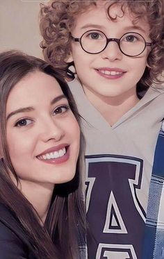 two young children are posing for the camera with glasses on their heads and one is smiling