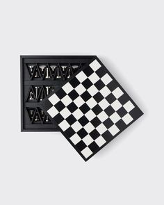 two pieces of black and white chess board with letters on each side, one in the middle