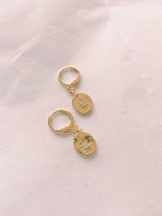 Available in CZ Huggie Hoops: https://www.etsy.com/listing/919494888/north-star-coin-cz-huggie-hoop-earrings?ref=shop_home_active_3&frs=1 I personally source and assemble all my Jewelry Pieces with love in California ♡ Usually processing time is 1-2 days - I work on my business everyday :) All packages come with delivery insurance. Choose the USPS shipping time best fit for you. These gold huggie hoops are genuine 18k Gold plated. Each item is manufactured to the highest quality specificatio Gold-plated Dangle Huggie Earrings, Tarnish Resistant Gold Dangle Huggie Earrings, Tarnish-resistant Gold Dangle Huggie Earrings, Handmade Huggie Gold Plated Hoop Earrings, Handmade Huggie Hoop Earrings In Gold Plated, Handmade Gold Plated Huggie Hoop Earrings, Handmade Gold Plated Dangle Huggie Earrings, Gold Round Huggie Earrings In 14k Gold Filled, Gold Dainty Hoop Earrings For Gift