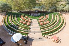 an outdoor seating area with tables and umbrellas set up in the shape of a circle