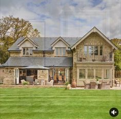 a large house sitting on top of a lush green field next to a lawn covered in lots of grass