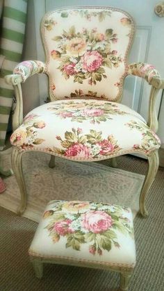 an old chair and footstool with flowers on it