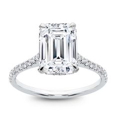 an emerald cut diamond ring with pave set shoulders