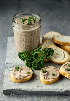 some breads are sitting on a cutting board next to a jar of peanut butter