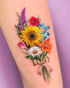 a colorful bouquet of flowers on the right side of the leg is shown with a bow