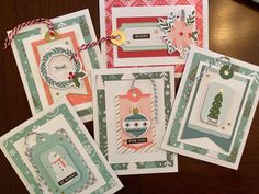 four christmas cards with tags attached to them