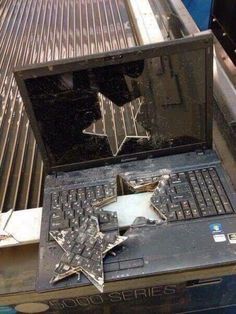 an open laptop computer sitting on top of a metal table