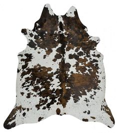 a brown and white cowhide rug on a white background