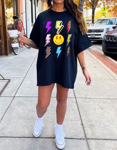 ABOUT OUR Lighting Bolt Shirt: PRODUCTION TIME: 1-3 days (Usually 2 days) SHIPPING TIME: 2-5 days (Usually 3 days) PRODUCT DESCRIPTION: Bella Canvas Unisex T-shirt Super soft cotton and excellent quality print makes. 100% Soft cotton (fibre content may vary for different colors) Light fabric (4.2 oz/yd² (142 g/m Runs true to size Our Relaxed Fit Tee (Bella + Canvas style 3001) is a unisex style that runs a touch small for men, and about a half a size large for women. It's a relaxed fit and is soft and cozy. * For T-shirt Sizes Please refer to the Listing Image. CARE INSTRUCTION: Machine wash: warm (max 40C or 105F); Non-chlorine: bleach as needed; Tumble dry: low heat; Iron, steam or dry: medium heat; Do not dryclean PRINTING METHOD: DTG printing method is used for these shirts. A process Cheetah Lightning Bolt Shirt, Lightning Bolt Outfit, Fun Black Tops With Graphic Design, Black Relaxed Fit Fun T-shirt, Fun Black Relaxed Fit T-shirt, Fun Black Tops With Screen Print, Fun Black Printed Top, Fun Black Printed T-shirt, Fun Black Short Sleeve Shirt