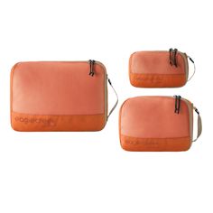 three orange bags sitting next to each other on a white surface with the words beagle creek printed on it