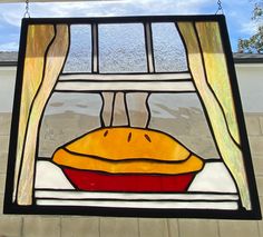 a stained glass window with a bread on it