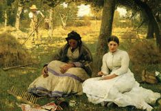 two women sitting in the grass near trees