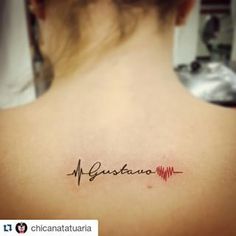 the back of a woman's neck with a tattoo that reads gustato on it