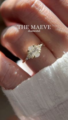 a woman's hand with a diamond ring on it and the words, the maeve diamond