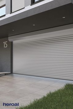 an image of a garage door with the number fifteen on it and grass in front