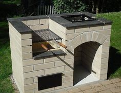 an outdoor brick oven with a grill on top