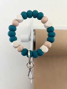 a blue and white beaded bracelet with a pair of scissors hanging from it's end