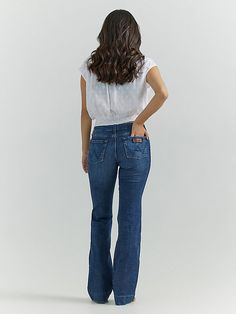 THE TROUSER: THE ULTIMATE IN WOMEN'S RETRO® JEANS Like all Wrangler Retro® jeans, our Mae wide-leg trouser jean is marked by its Western authenticity, making it a go-to style for cowgirls everywhere. With its contour waist and mid-rise fit, these women's trouser jeans are made to fit comfortably while they flatter all your curves. With more room at the knee and a gradual opening down the leg, the Mae wide-leg trouser gives you the room you need to stay active and in style. Womens Trouser Jeans, College Clothes, Retro Jeans, Stay Active, Wrangler Jeans, Dark Wash Denim, College Outfits, High Rise Jeans, Trouser Jeans